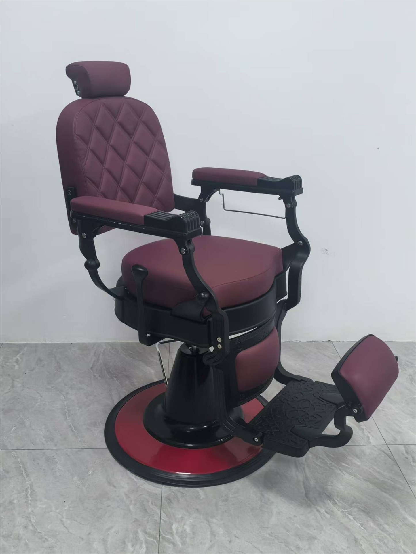 Exclusive barber chair in burgundy red with black base